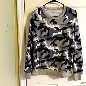 Long sleeve camouflage top for women. Name label is missing. Size M